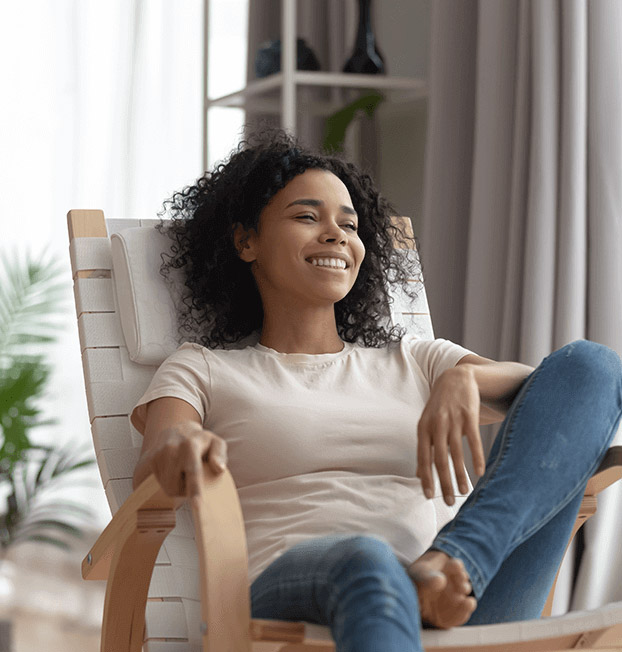 comfor-home-care-calabasas-black-woman-sitting-in-chair-happy-peace-of-mind-knowing-care-is-in-good-hands
