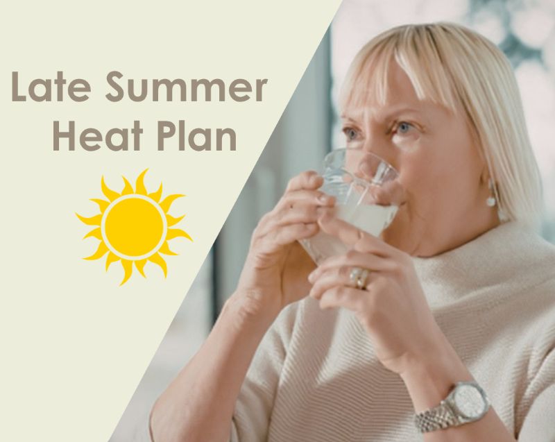 Older women drinking water- Late Summer Heat Plan