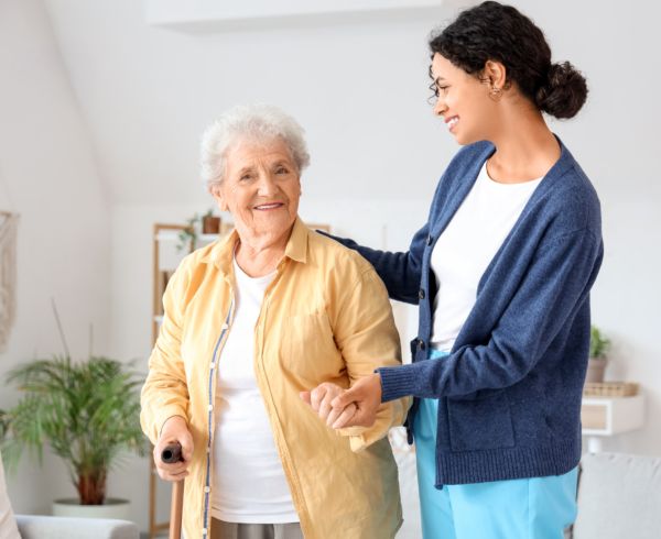 Caregiver with older women with cane
