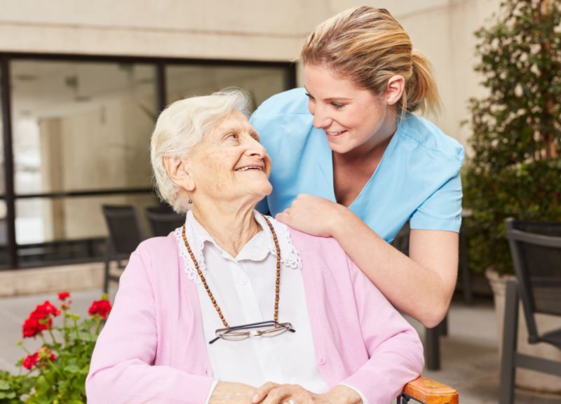 women caregiver helping elderly woman
