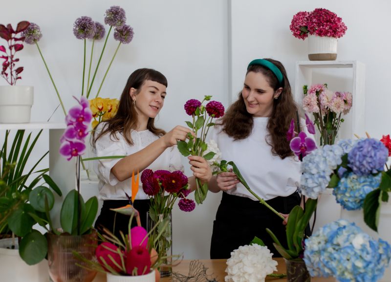 Two women working with flowers
