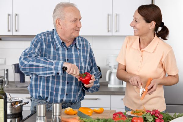 caregiver helping senior cook