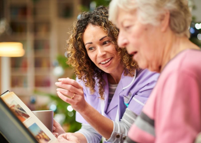 Women sitting together looking at photos
