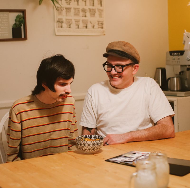 two adults talking at table