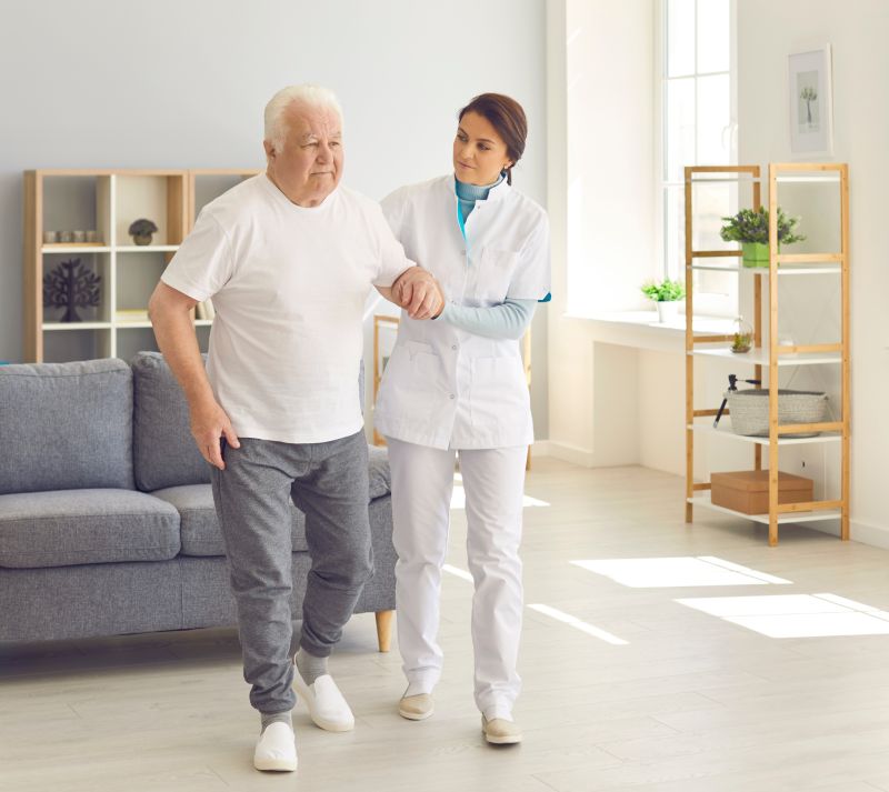 caregiver helping senior with rehab
