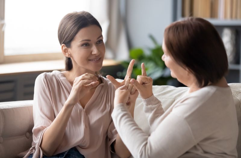 2 women talking with sign launguage