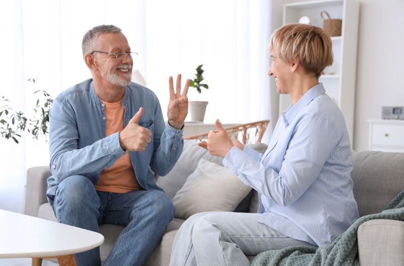 2 adults doing sign language