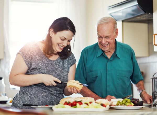 daughter helping father in kitchen