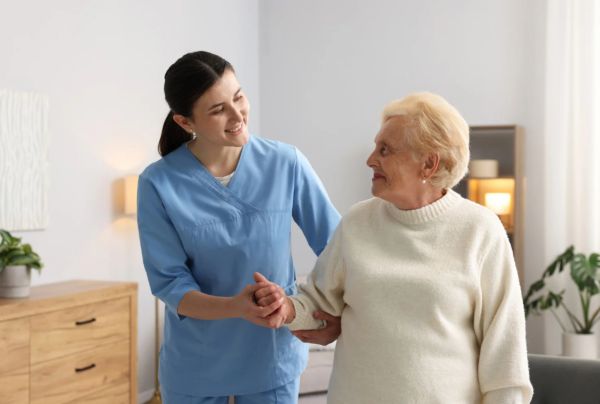 caregiver helping senior walk