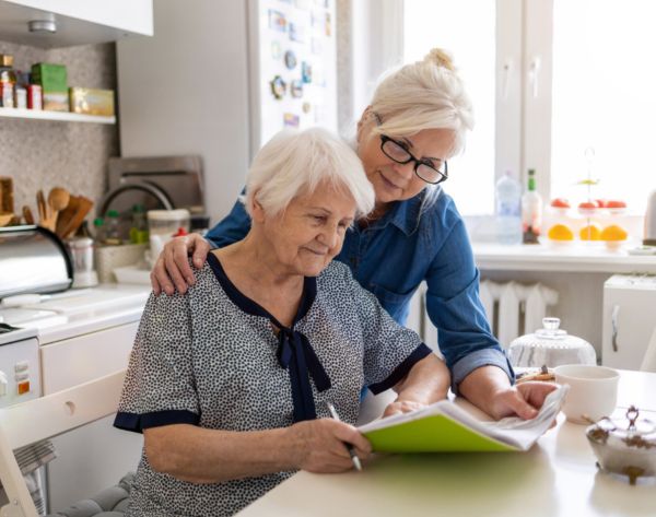 two women looking at a book