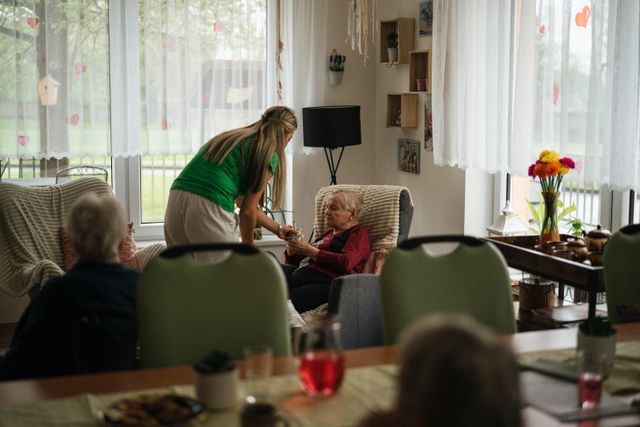Caregiver helping an older adult at home.