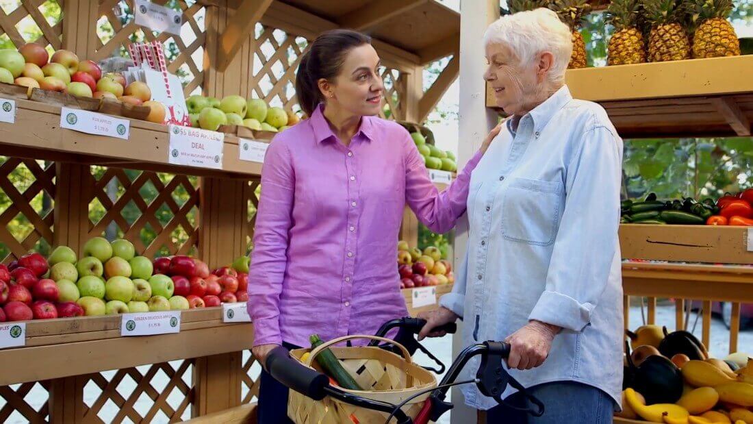 Younger nurse shopping with older woman