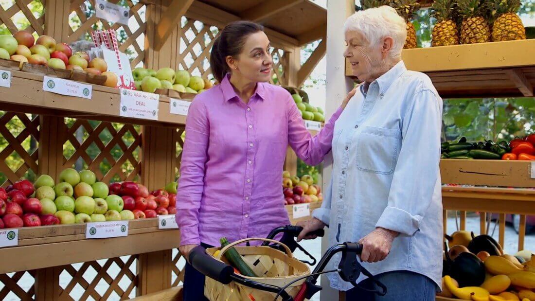 A woman collects food at a market.