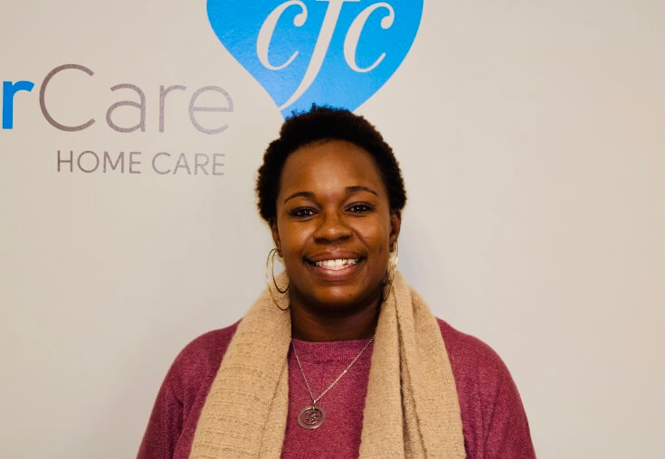 An in-home care nurse smiling next to the logo.