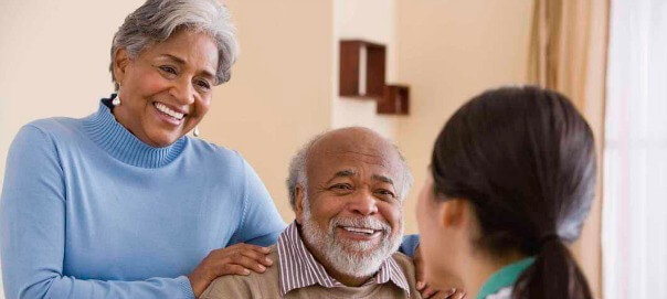 Older couple chatting with home nurse