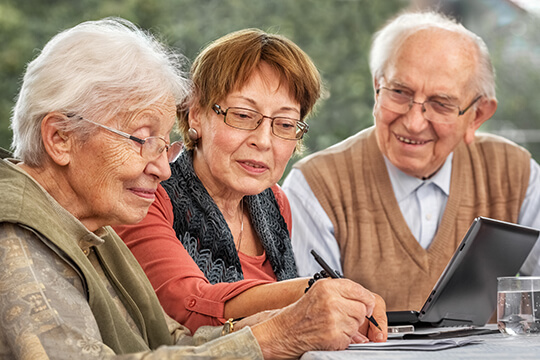Older people filling out paperwork