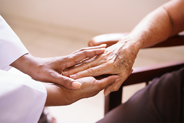 Young hands grasping older hands