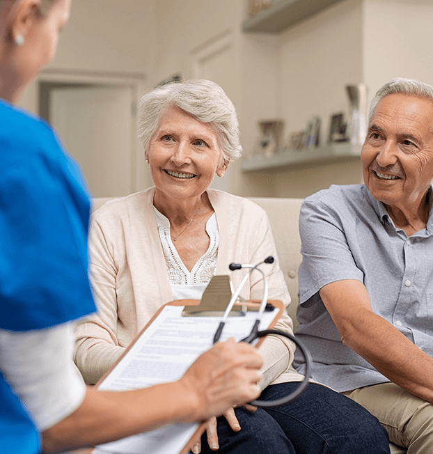 Older woman listening to younger nurse