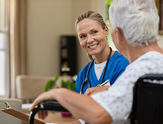 Young nurse smiling with older woman