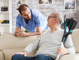 Younger nurse talking to older man