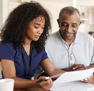 A nurse explains her care services to a patient.