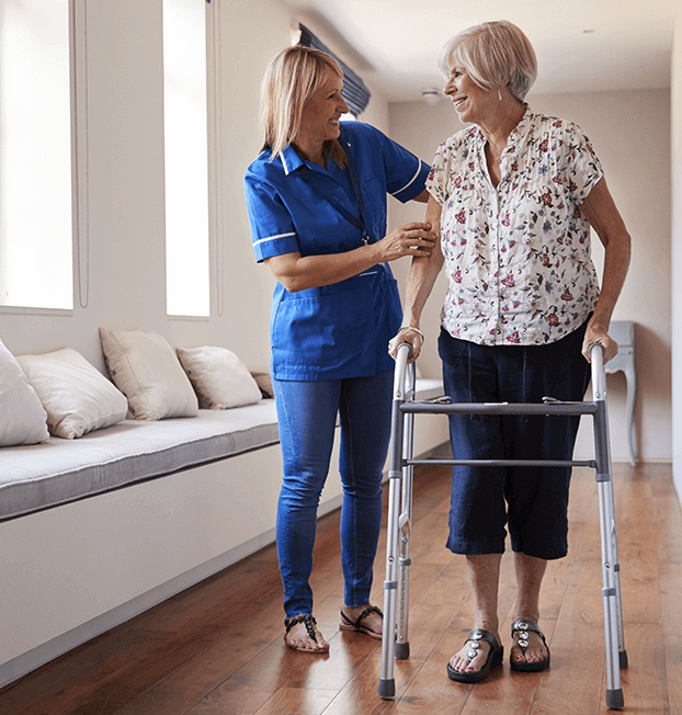 Young nurse helping older woman walk