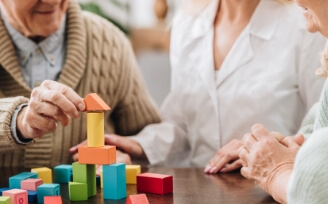 Older man playing with memory blocks