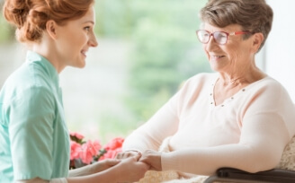 Young nurse smiling with older woman