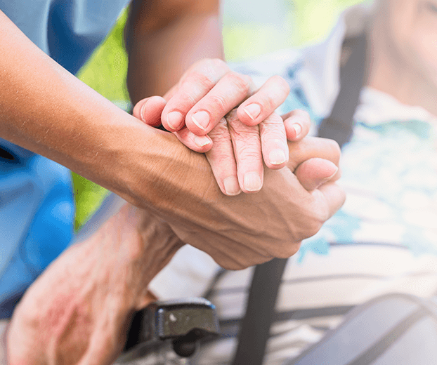 Older woman and Caregiver hands together