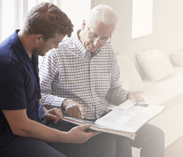 Home nurse going over charts with elderly man