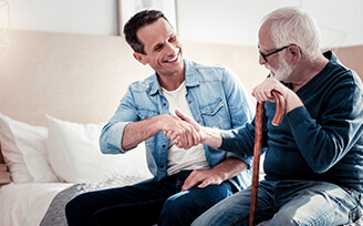 Man shaking hands with elderly man