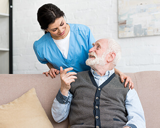 Older man talking to younger nurse