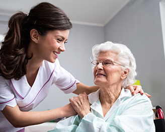 Young nurse smiling with older woman