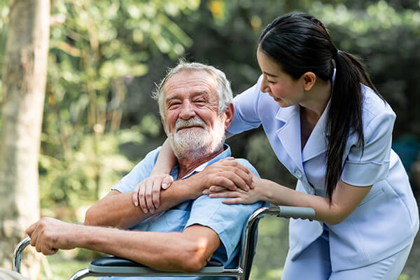 Home nurse taking older man outside