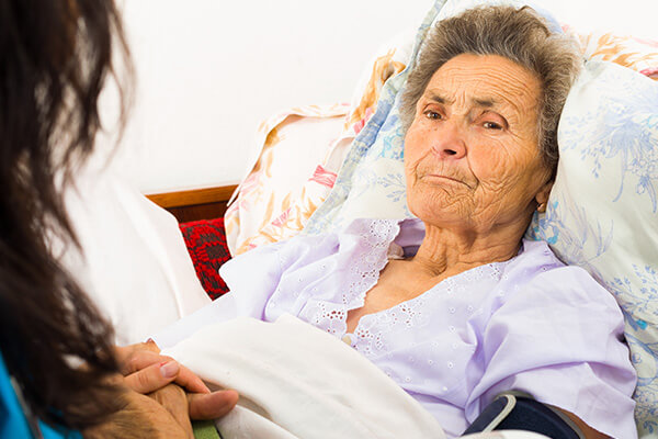 Home nurse caring for elderly woman