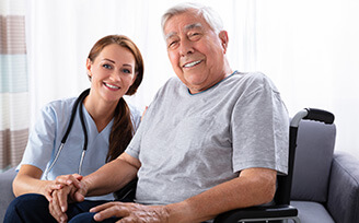 Elderly man smiling with a home nurse