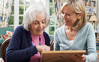Younger woman showing a photograph to older woman