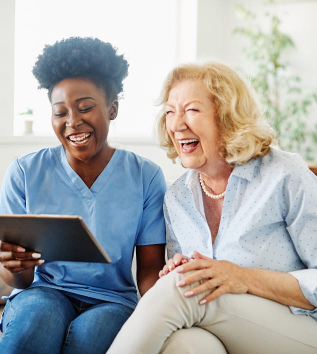 A professional caregiver and a senior with memory loss engaging in meaningful activities together