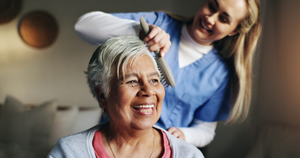 Alzheimer's caregiver brushes a client's hair in New Braunfels