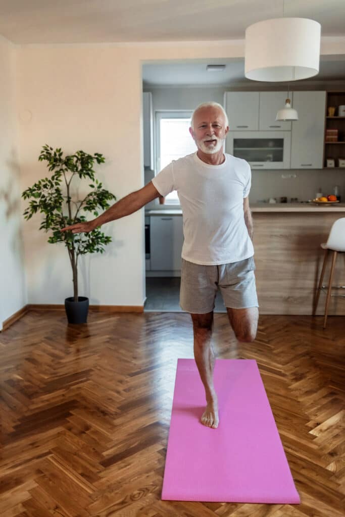 Older adult practicing balance exercises at home.