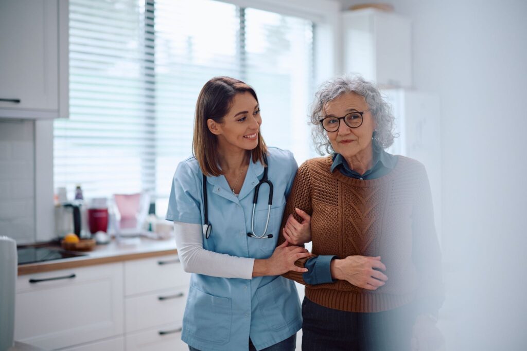 A caregiver and older adult talking together at home in New Braunfels, TX.