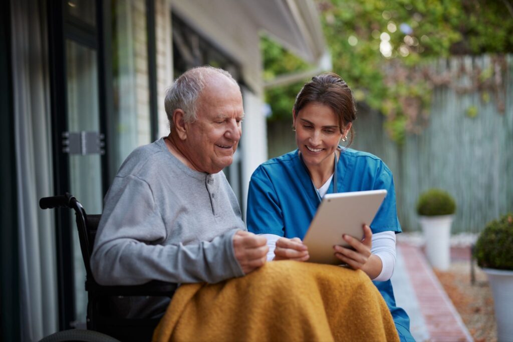 A caregiver and older adult talking together at home in New Braunfels, TX.