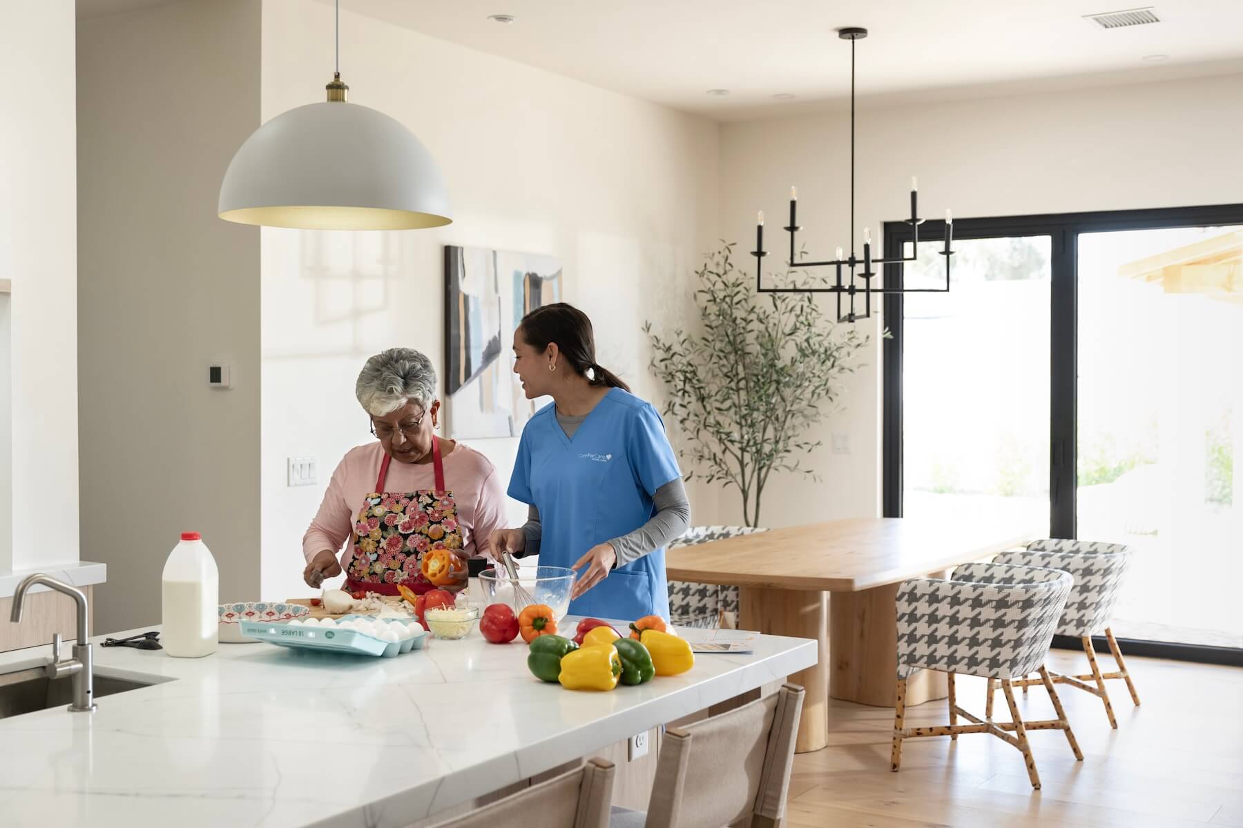 ComForCare Caregiver Helping a senior woman with meal prep in Milwaukee County.