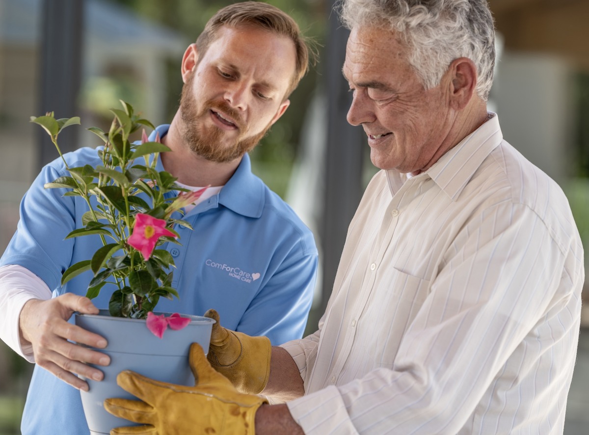 ComForCare Caregiver helping a client with gardening in Milwaukee County.