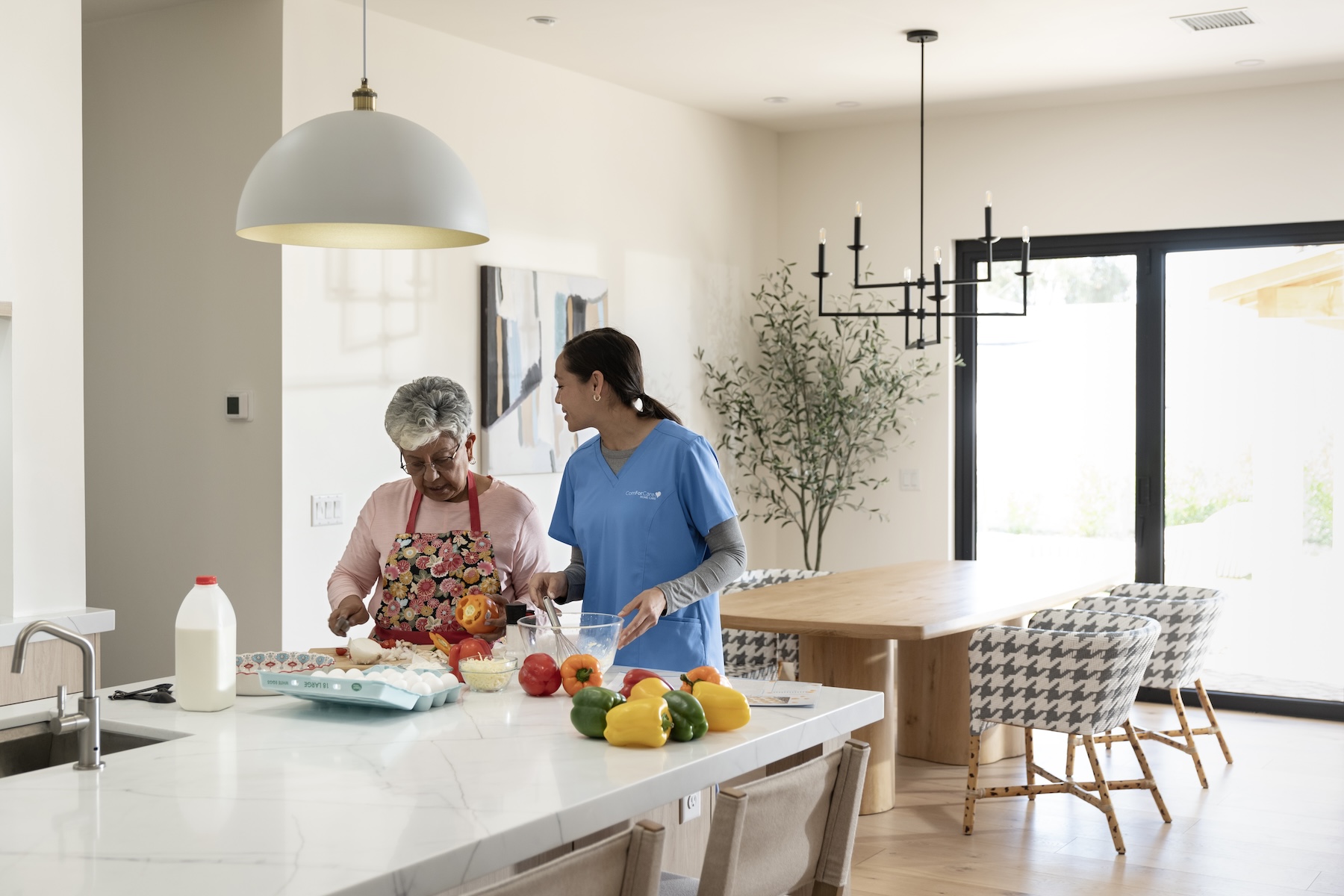 ComForCare Caregiver Helping a senior woman with Meal prep in Waukesha County.