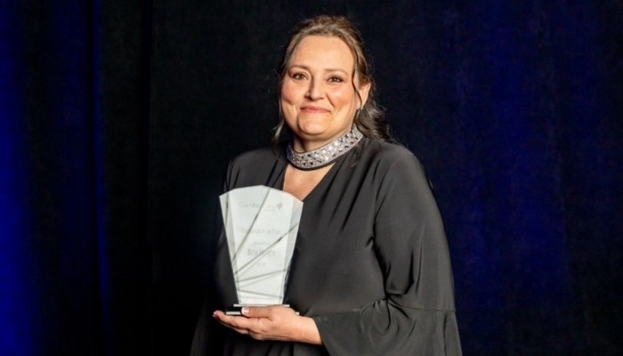 Photo of Beth winning an award.