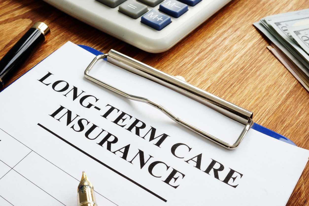 A graphic of a clipboard and calculator for long-term care insurance.